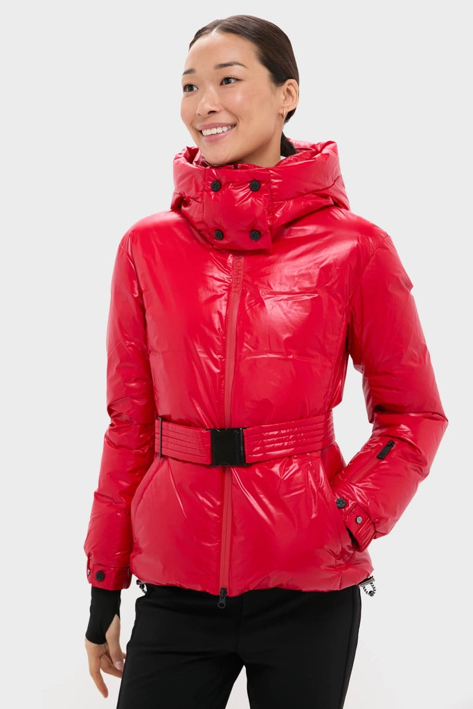 Model wearing the classic, high-end Red Candice Ski Parka with a wide belt, showcasing its effortless, streamlined style and fun, practical features for alpine adventures.