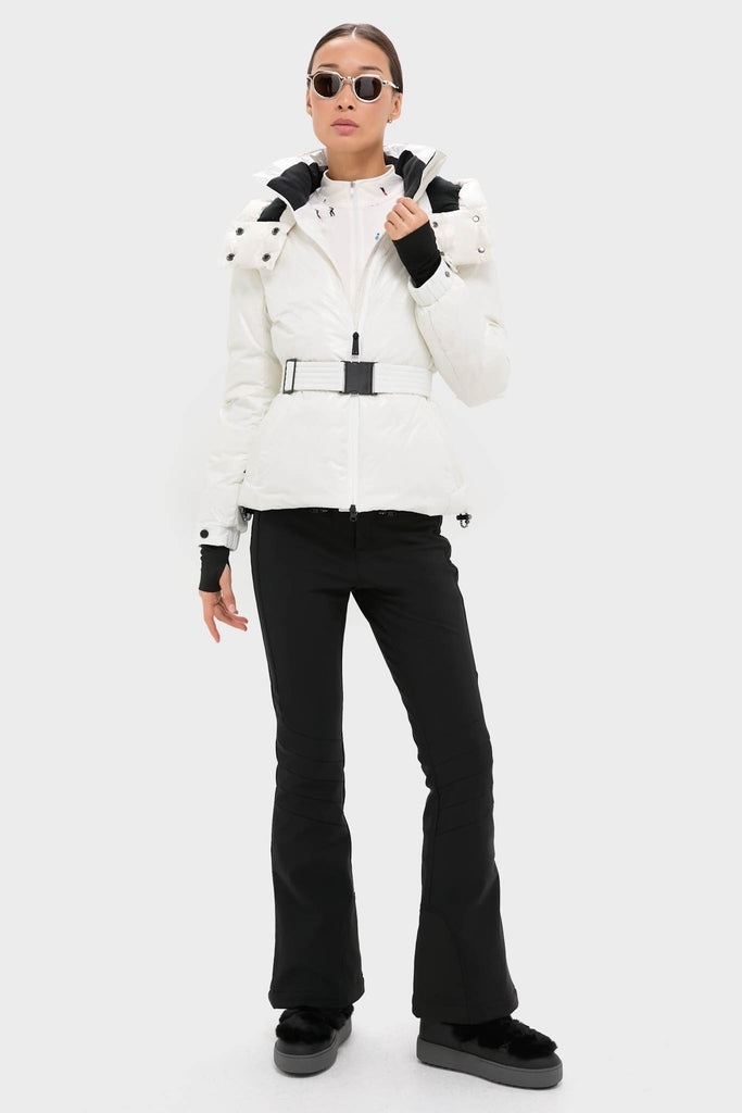 Model in Snow White Candice Ski Parka, a high-end, classic winter-sports jacket with detachable hood, belted waist, and performance features, embodying effortless, fun alpine style.