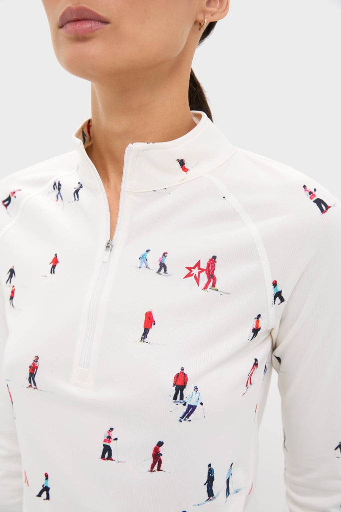 Dede Ski Print 1/4 Zip Base Layer Top, featuring classic skiers pattern, quarter-zip mock neck, and moisture-wicking fabric, offers an effortless, high-end style for fun on the slopes.