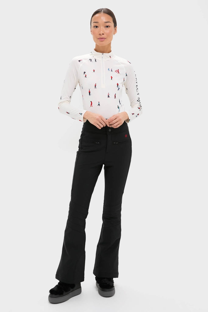 Model wearing Dede Ski Print 1/4 Zip Base Layer Top, showcasing classic, effortless style with fun ski silhouettes. Paired with sleek pants, embodying high-end performance and comfort.