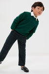 Young boy modeling the Forest Green Bromo Merino Boy Jumper, a classic, high-end sweater with raglan sleeves and shoulder buttons, paired with plaid trousers and loafers.