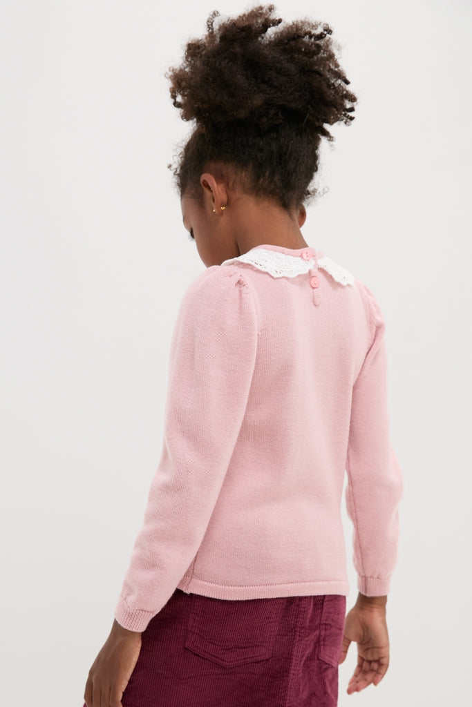 Young girl in a classic, dusty pink Blanca Merino Wool Girl Jumper with a lace collar and relaxed fit, capturing effortless and high-end style.
