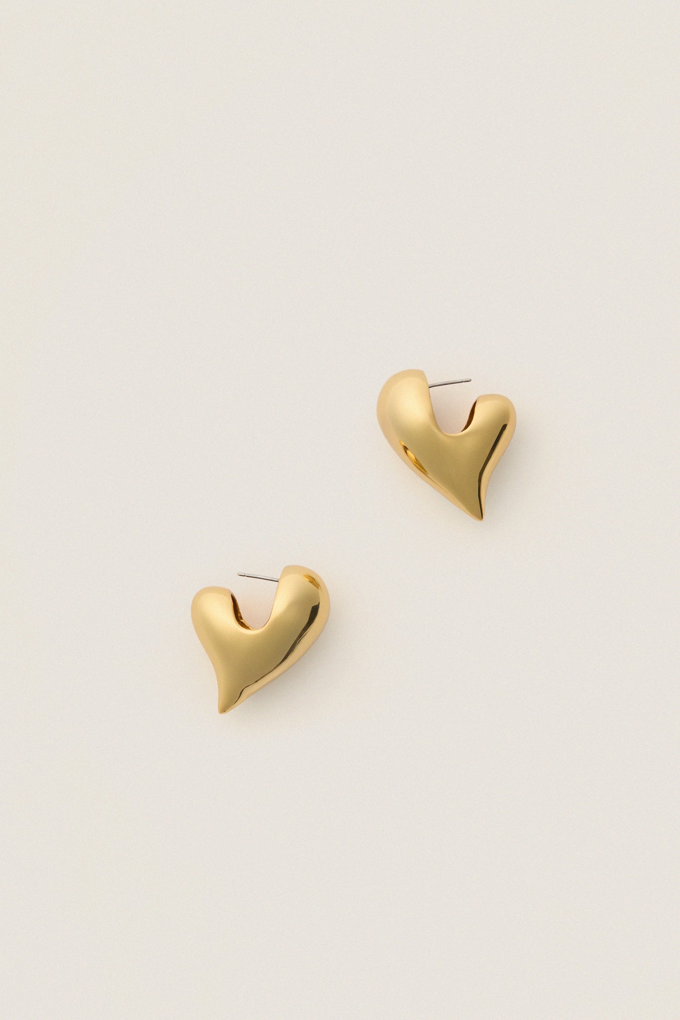Classic, effortless High Polish Gold Art Heart Earrings with a fun, sculptural design; polished contours and post back closure offer a high-end, playful twist.