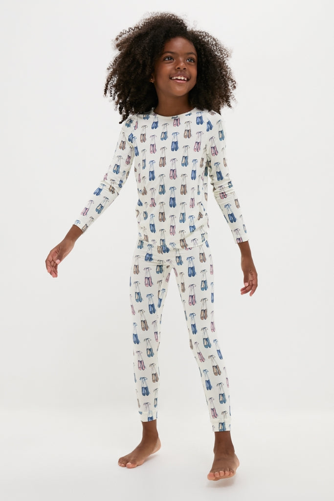 Young girl in classic, high-end Ballet Slippers Kids Bamboo Pj Set, showcasing effortless style with fun ballet-shoe print, perfect for cozy, breathable comfort.