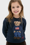 Young girl wearing the Boys Long-Sleeve Flag Bear Crewneck Sweater, featuring a classic Polo Bear in an effortlessly fun, high-end design by Ralph Lauren.