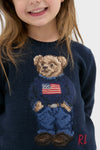 Child wearing Boys Long-Sleeve Flag Bear Crewneck Sweater, featuring a classic Polo Bear in an American flag sweater, exuding an effortless, high-end and fun style.
