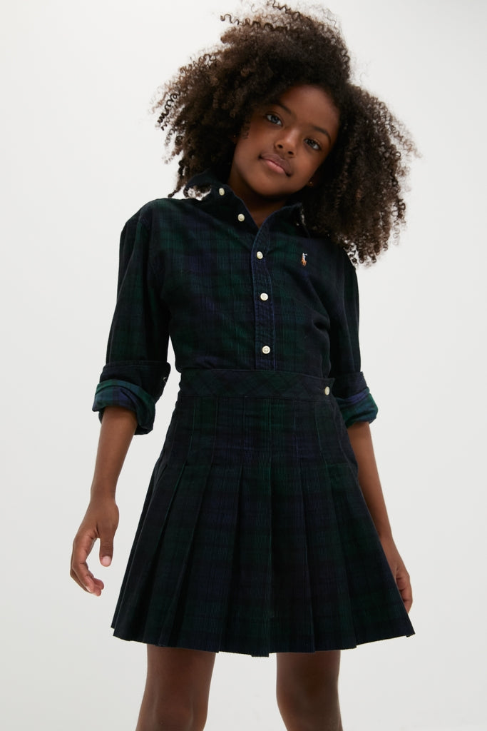 Young girl in a classic, effortless Girls Long-Sleeve Cotton Printed Corduroy Shirt with Pleated Skirt set, showcasing fun, high-end style for any occasion.
