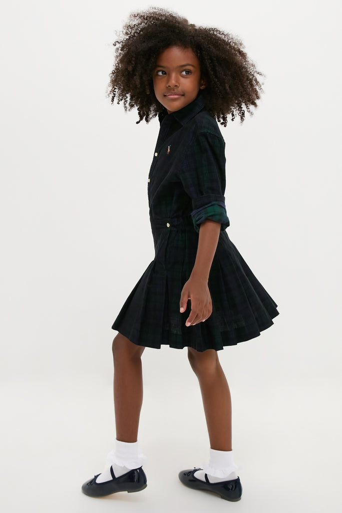 Young girl in profile wearing a classic, effortless Girls Long-Sleeve Cotton Printed Corduroy Shirt with Pleated Skirt, embodying fun and high-end style.