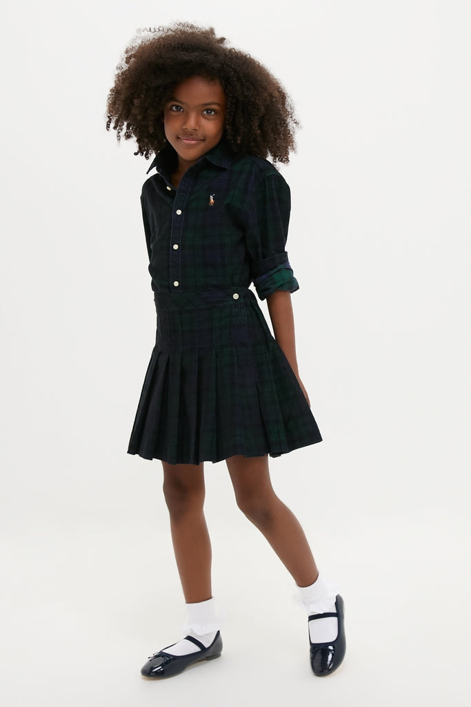 Young girl wearing the classic, high-end Girls Long-Sleeve Cotton Printed Corduroy Shirt with Pleated Skirt, exuding an effortless and fun style.