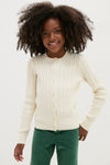Young girl in a classic, effortless Girls Long-Sleeve Cotton Cable Knit Lurex Cardigan, smiling slightly, embodying Polo Ralph Lauren's high-end, fun style with ribbed hems and signature details.