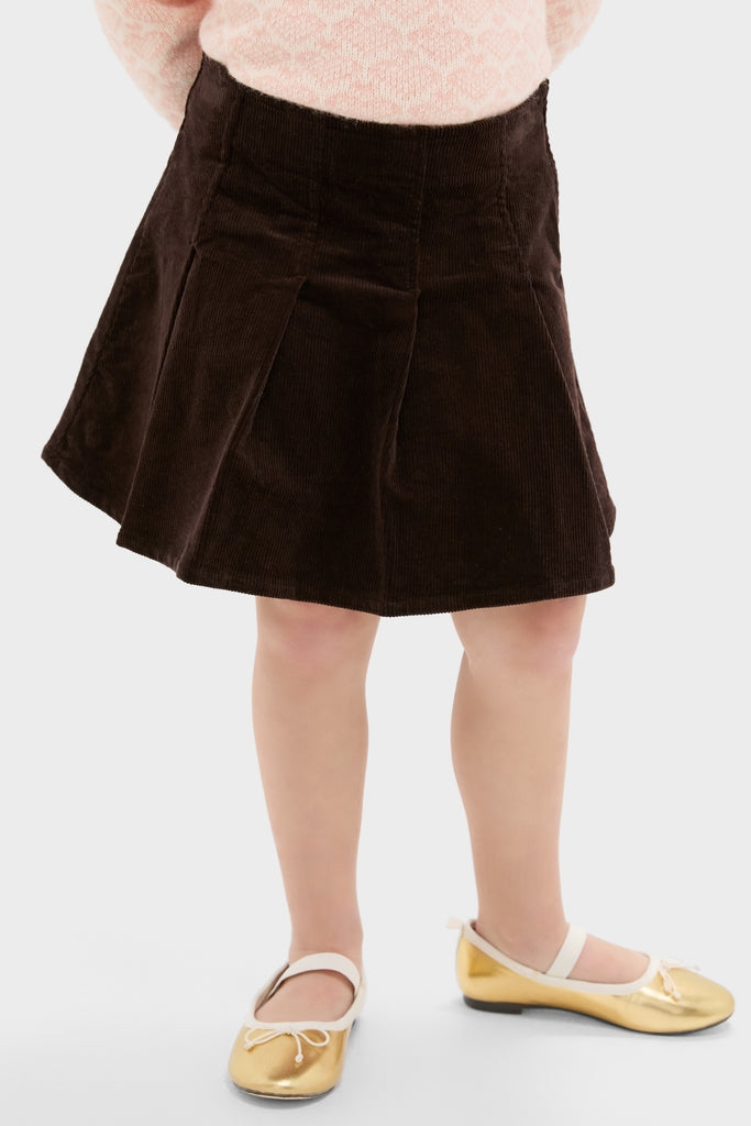 Girls Pleated Corduroy Skirt: A classic, high-end style with effortless charm, featuring pleats and gold Mary-Jane flats for a fun, sophisticated look.