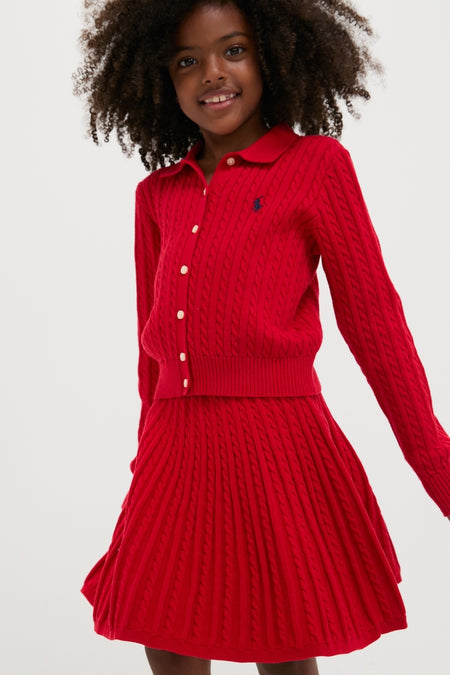 Young girl smiling in a classic, high-end Long-Sleeve Cotton Mini Cable Knit Cardigan with Matching Skirt, exuding effortless and fun style.