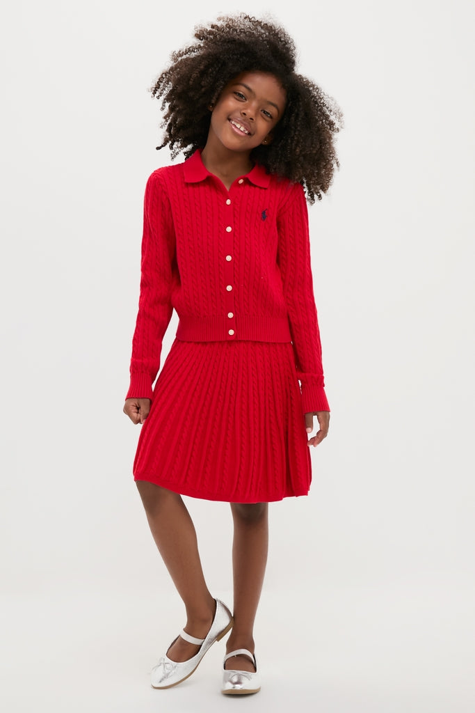 Young girl in an effortless, classic Long-Sleeve Cotton Mini Cable Knit Cardigan with Matching Skirt, embodying fun and high-end style with Polo Ralph Lauren's signature design.