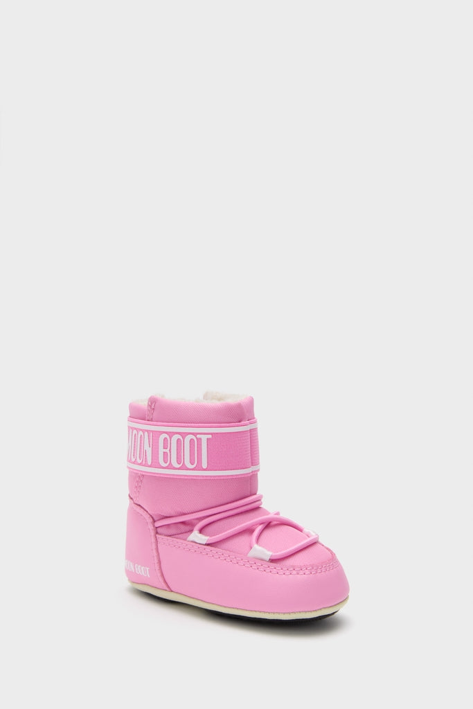 Kids Light Pink Crib Nylon Boots feature a classic Moon Boot design with a thick insulated sole, fleece lining, and effortless wide strap for a high-end, fun look.