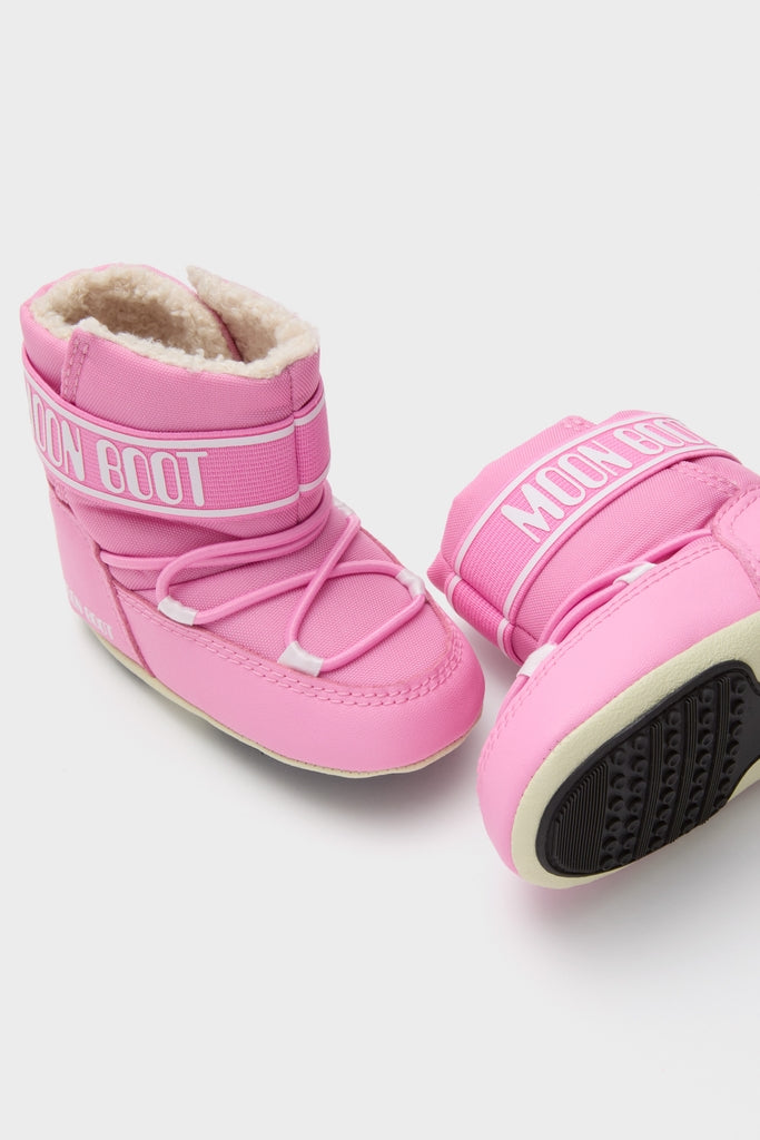 Kids Light Pink Crib Nylon Boots featuring a classic, effortless Moon Boot design with fun padded insulation, elastic lacing, and high-end traction outsoles, perfect for winter adventures.