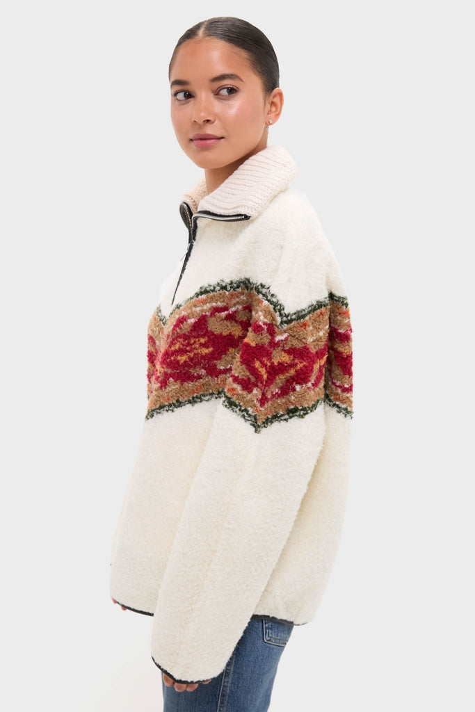 Young woman models the Ecru Marner Pullover—classic sherpa fleece with a high collar and multicolored stripe—offering an effortless, high-end style with a fun twist.