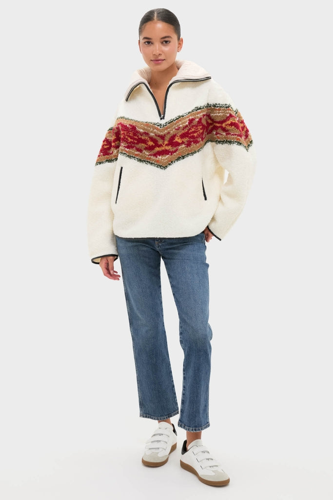 Model wearing the classic Ecru Marner Pullover with a red-and-orange band, paired effortlessly with straight-leg jeans and fun, high-end white sneakers.