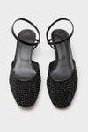 Black Crystals Erika Pump Sandals: Classic sling-back flats adorned with black rhinestones, featuring a low square toe and thin heel strap for an effortless, high-end look.