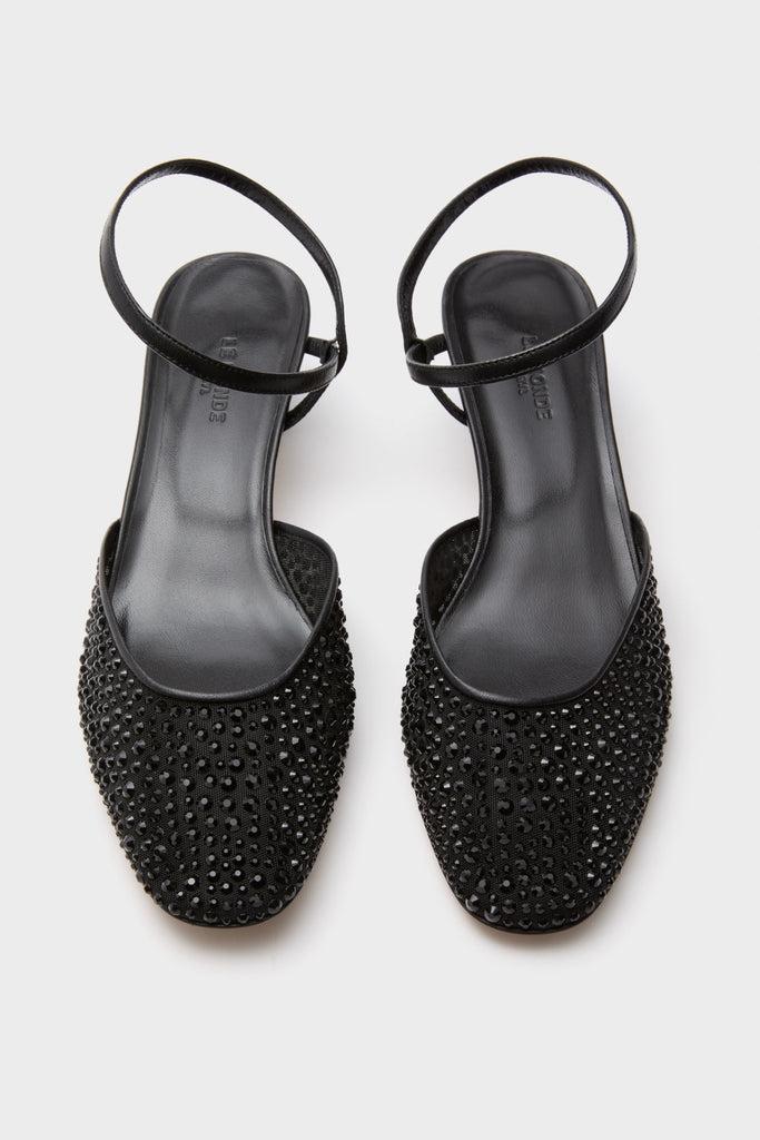 Black Crystals Erika Pump Sandals: Classic sling-back flats adorned with black rhinestones, featuring a low square toe and thin heel strap for an effortless, high-end look.