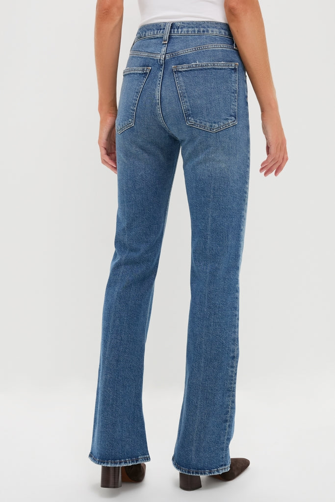 Curve Mid Rise Kick Boot jeans, featuring a classic mid-rise and kick flare hem, crafted from soft, comfort stretch denim, styled with an effortlessly cool white top and ankle boots.