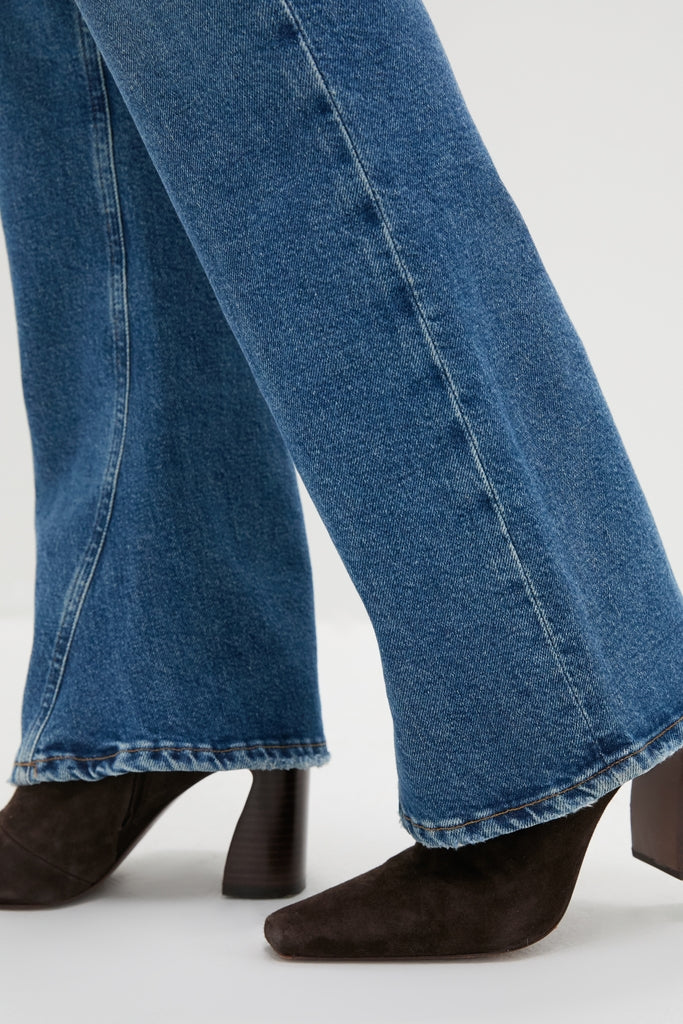 Curve Mid Rise Kick Boot jeans with a classic bootcut and subtle flare, paired with suede ankle boots, create an effortless, high-end look perfect for fun outings.