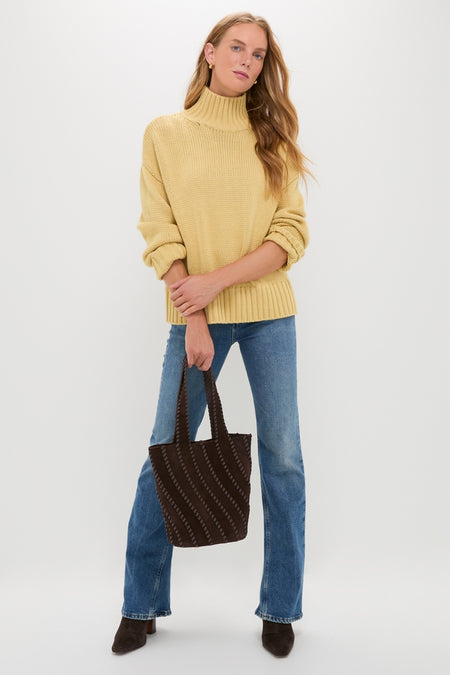 Curve Mid Rise Kick Boot jeans offer a classic, effortless look, paired with a chunky turtleneck, suede ankle boots, and a stylish tote for a high-end, fun ensemble.