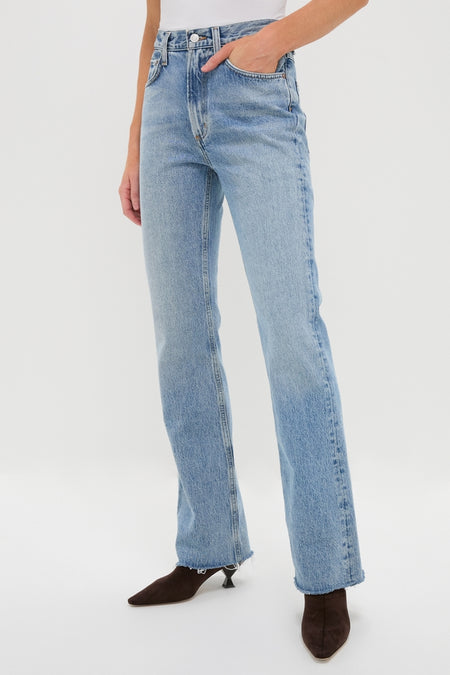 Model wearing Stage Leena Jean, a classic high-rise, straight-leg style with raw-edge hem. Effortless and fun, paired with a white top and dark brown boots.