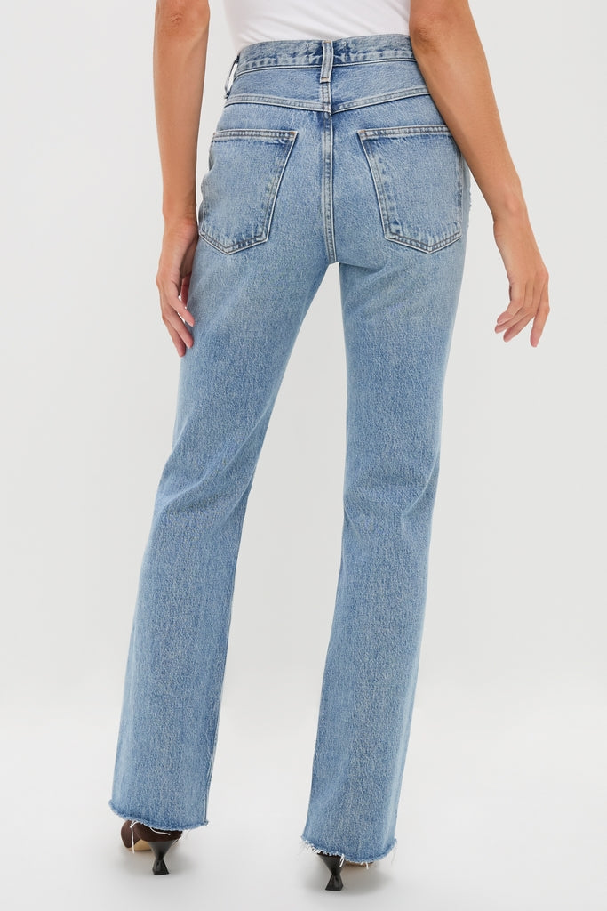 Model in high-rise Stage Leena Jean with classic straight-leg fit, raw hem, and patch pockets, paired with a white top and heels for an effortless, high-end look.