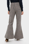 Nude Trail Farah Dust Pant, classic high-waisted flared trousers in a gingham pattern, paired with dark heeled mules for an effortless, fun, high-end look.
