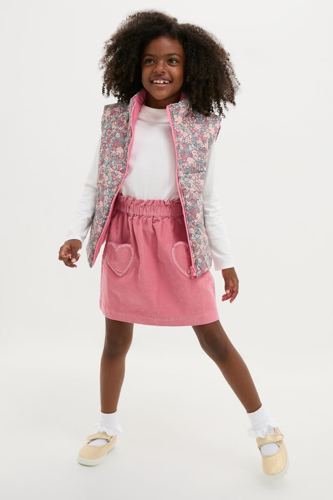 Young girl models the classic, reversible Floral Padded Gilet, effortlessly styled with a zip-front and floral print, embodying fun and high-end versatility.