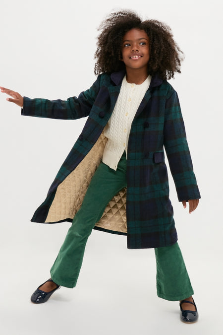 Young girl in a classic Blackwatch Velvet Trim Coat, showcasing effortless style with velvet accents, embodying a fun, high-end look from Tuckernuck.