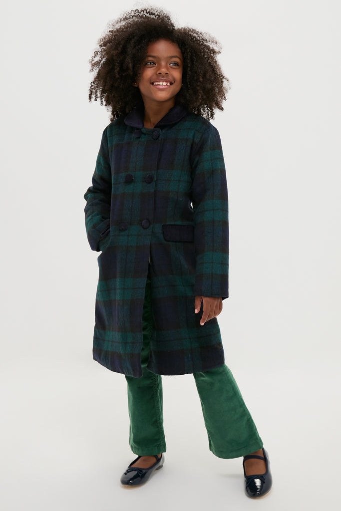 Young girl in a classic Blackwatch Velvet Trim Coat, showcasing effortless style with luxurious velvet accents, embodying fun and high-end sophistication.
