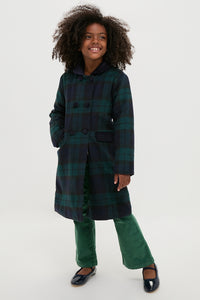 Young girl in a classic Blackwatch Velvet Trim Coat, showcasing effortless style with luxurious velvet accents, embodying fun and high-end sophistication.