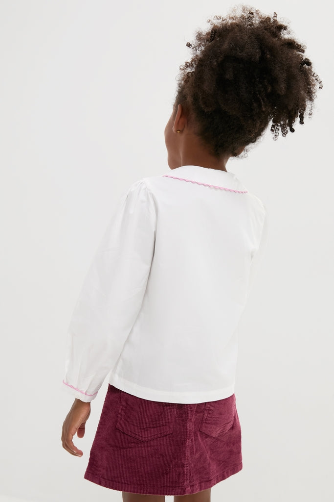 Classic Ric Rac Blouse: Effortlessly stylish with pink rick-rack accents, perfect for your little fashionista. High-end craftsmanship makes it fun and versatile for any occasion.