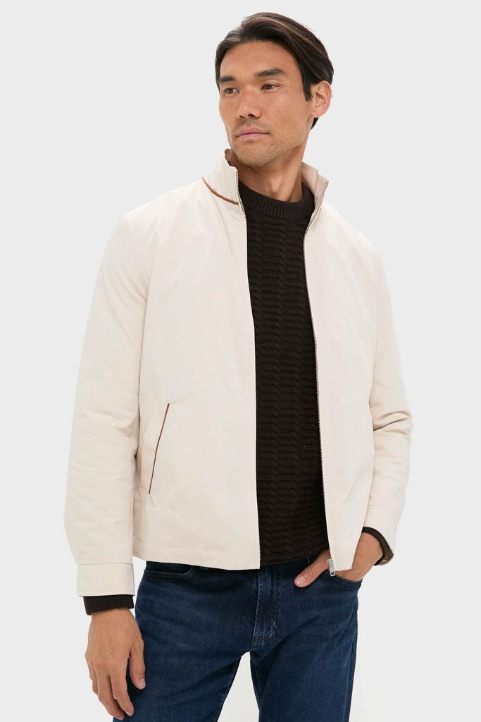 Man wearing the Tan Stanley Jacket, a classic, high-end piece with suede-trimmed pockets, over a cable-knit sweater, paired with dark jeans for an effortless, fun look.