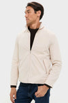 Model wearing an effortless, high-end Tan Stanley Jacket over a dark sweater and jeans. The classic design combines vintage charm with modern comfort, reflecting Tuckernuck's fun, confident style.