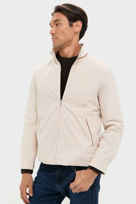 Model wearing an effortless, high-end Tan Stanley Jacket over a dark sweater and jeans. The classic design combines vintage charm with modern comfort, reflecting Tuckernuck's fun, confident style.