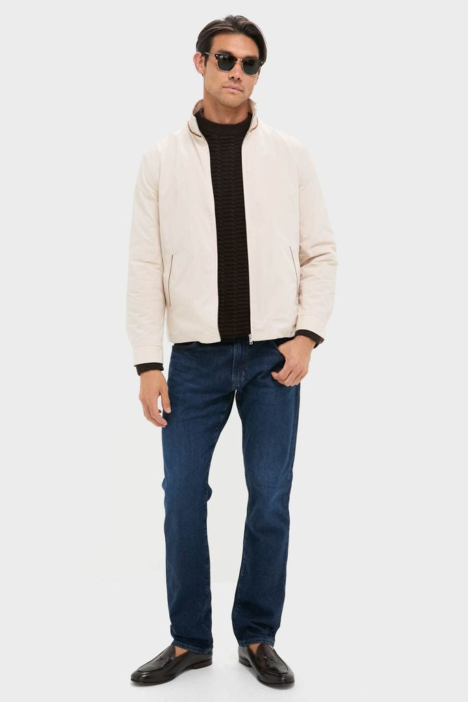 Model in Tan Stanley Jacket, a classic reimagined for modern wear, styled effortlessly with jeans and loafers, embodying high-end, fun sophistication from Tuckernuck.