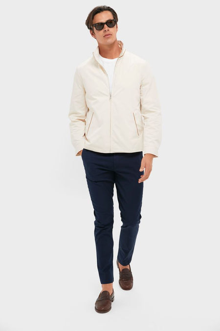 Model in Tan Stanley Jacket, showcasing a classic, effortless style with zip-up design, suede-trimmed pockets, and casual elegance, perfect for high-end, fun fashion.