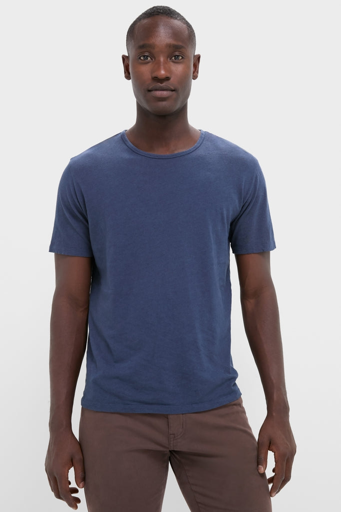 Young man models the classic Nautical Blue Drift Linen Tee, offering an effortless, high-end summer look with its relaxed fit and slubbed texture.