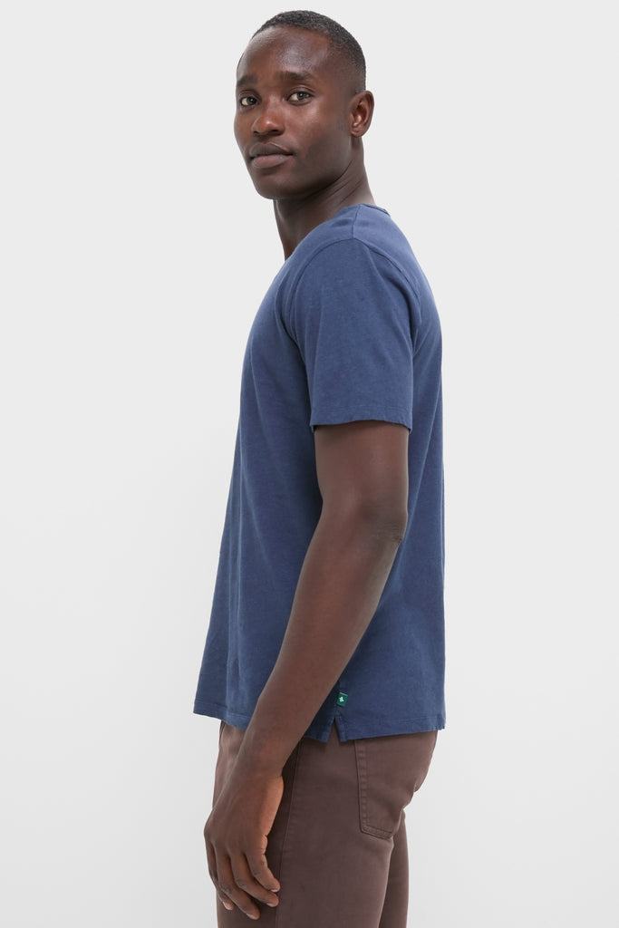 Effortlessly cool young man in a classic Nautical Blue Drift Linen Tee, showcasing its relaxed fit and high-end, soft, slubbed texture ideal for summer casual wear.