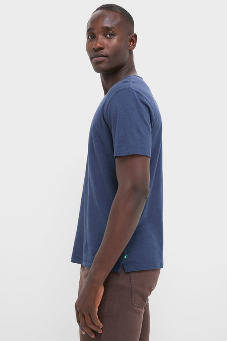Effortlessly cool young man in a classic Nautical Blue Drift Linen Tee, showcasing its relaxed fit and high-end, soft, slubbed texture ideal for summer casual wear.