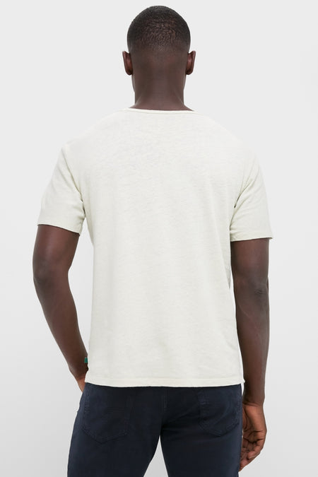 Back view of a person wearing the Sand Drift Linen Tee, showcasing its classic, relaxed fit and slightly slubbed texture, embodying effortless, high-end style.