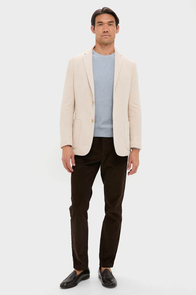 Man wearing the Tan Knit Travel Blazer, a classic, high-end piece for effortless style; perfect for travel with its wrinkle-resistant, sweater-soft cotton.
