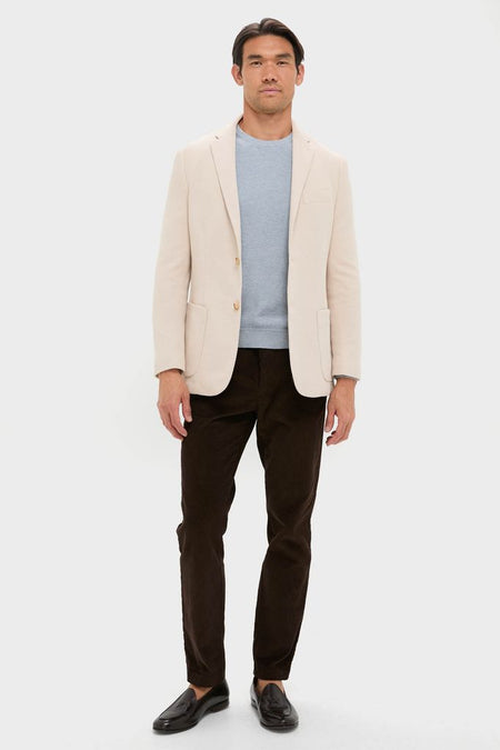 Man wearing the Tan Knit Travel Blazer, a classic, high-end piece for effortless style; perfect for travel with its wrinkle-resistant, sweater-soft cotton.