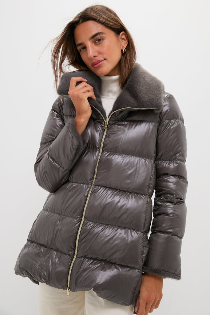 Woman modeling a classic, high-end Anthracite Nylon Ultralight Mid-Thigh Jacket with Faux Fur Collar, featuring effortless quilted design and fun gold-tone zipper.