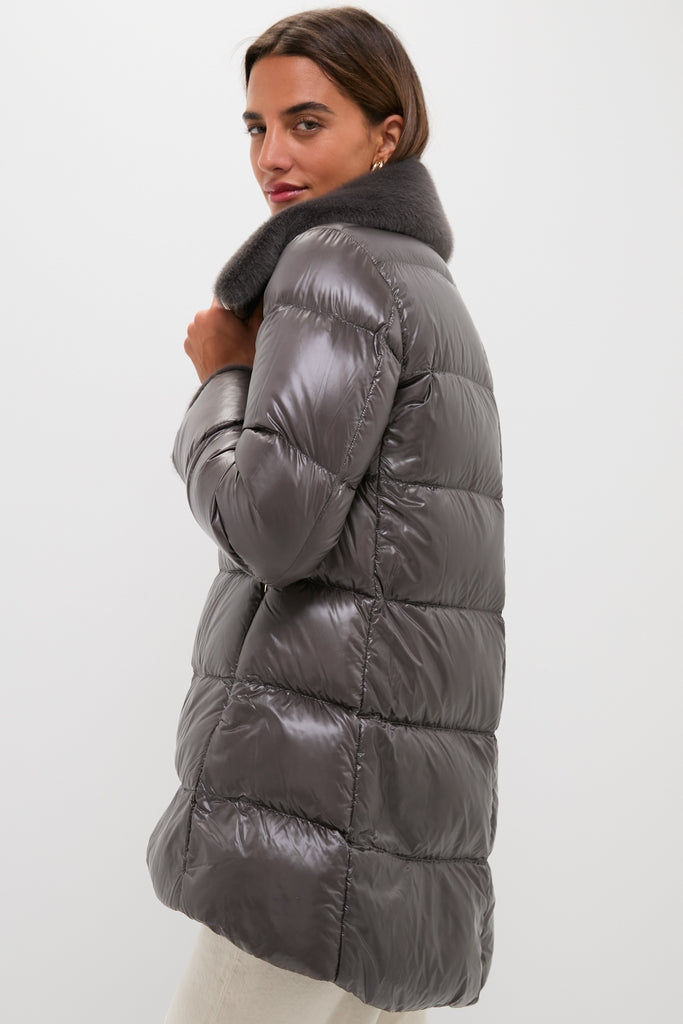Woman wearing an Anthracite Nylon Ultralight Mid-Thigh Jacket with Faux Fur Collar, showcasing a classic, effortless, high-end quilted design with fun faux fur trim.