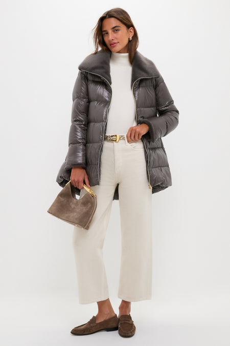 Woman models an Anthracite Nylon Ultralight Mid-Thigh Jacket with Faux Fur Collar, styled with effortless, high-end winter attire for a classic, fun look.