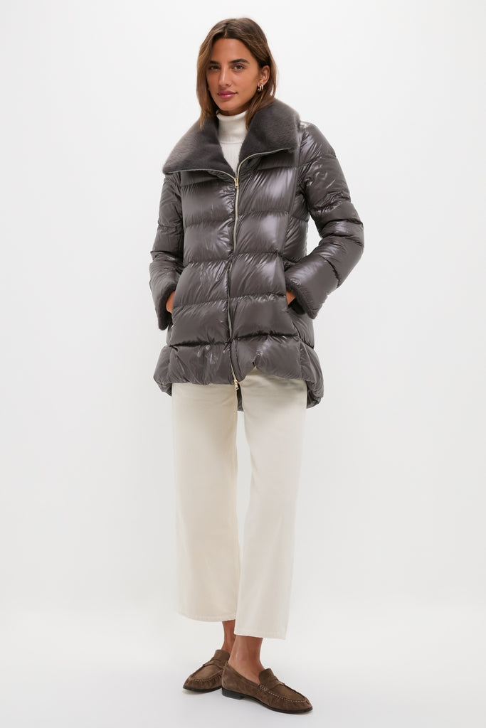 Woman models an Anthracite Nylon Ultralight Mid-Thigh Jacket with Faux Fur Collar, embodying classic, effortless style with chic details and high-end finish.