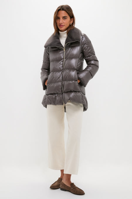 Woman models an Anthracite Nylon Ultralight Mid-Thigh Jacket with Faux Fur Collar, embodying classic, effortless style with chic details and high-end finish.